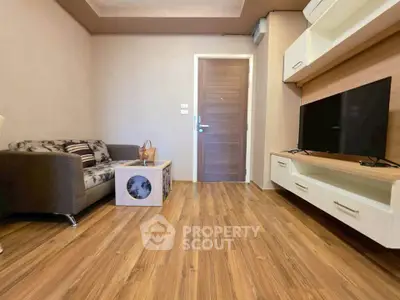 Modern living room with wooden flooring and sleek furniture design