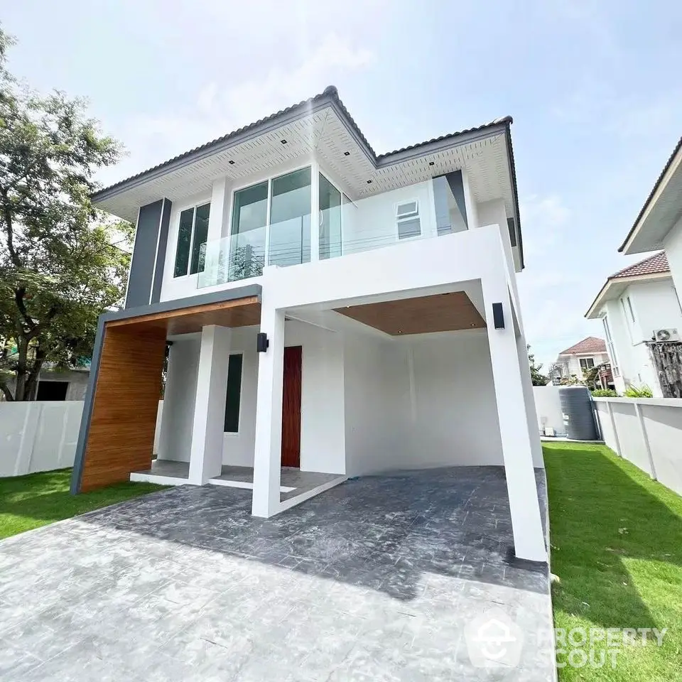 Modern two-story house with sleek design and spacious driveway