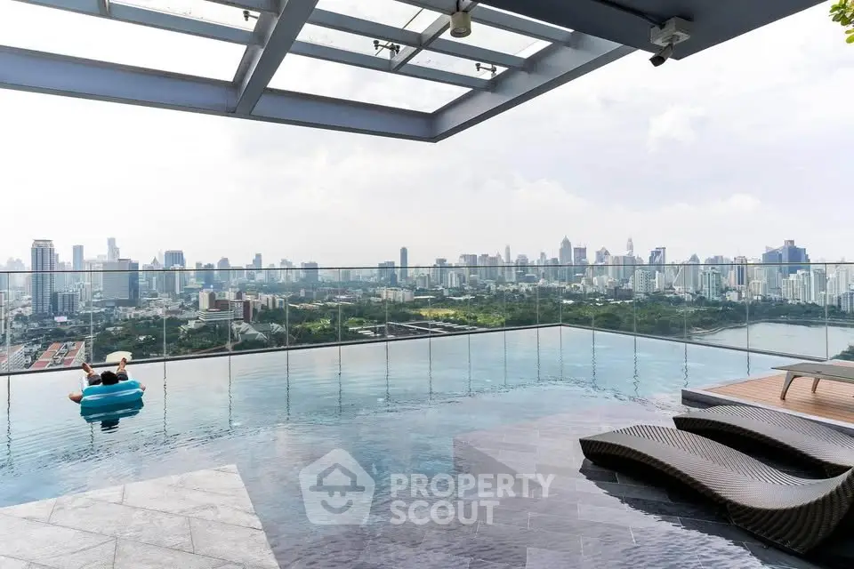 Luxurious rooftop pool with stunning city skyline view, perfect for relaxation and urban living.