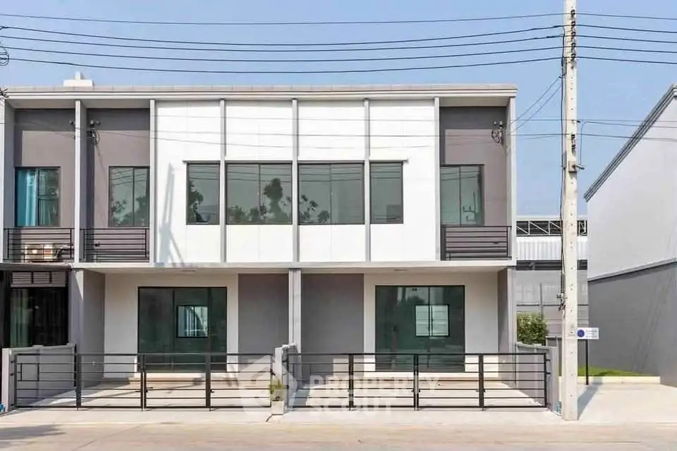 Modern townhouse exterior with sleek design and large windows
