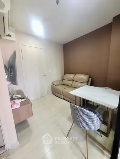 Cozy living room with modern furniture and neutral tones, perfect for relaxation and entertainment.