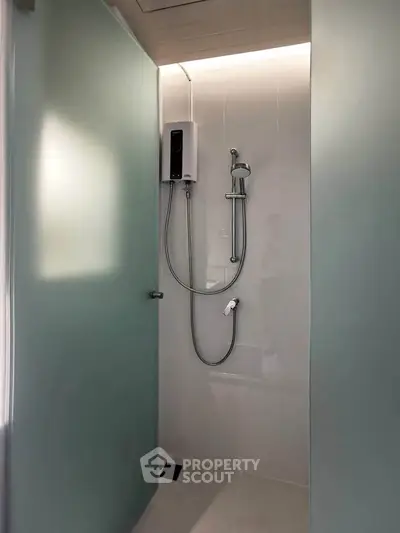 Modern bathroom shower with sleek design and glass partition in contemporary home.