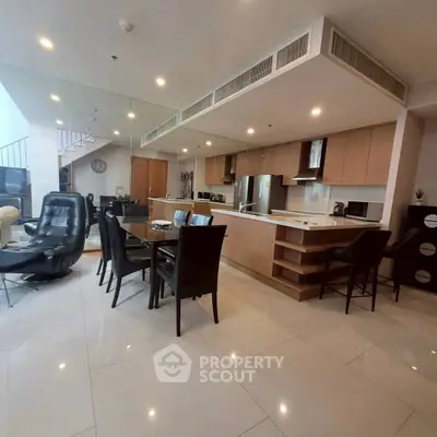 Spacious modern living room with open kitchen and elegant dining area in luxury apartment.