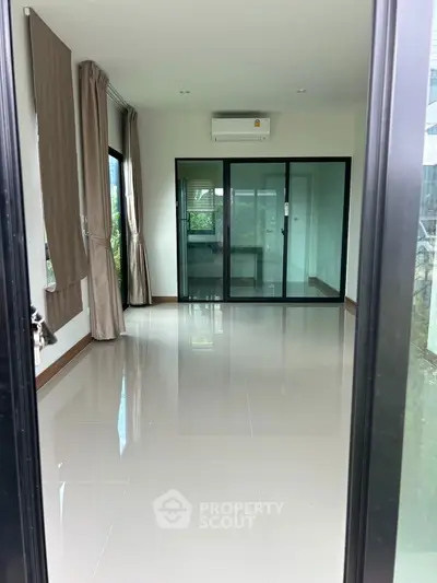 Modern living room with sleek design and large windows offering natural light.