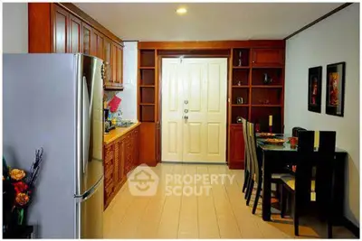 Charming kitchen with wooden cabinets and dining area in cozy apartment