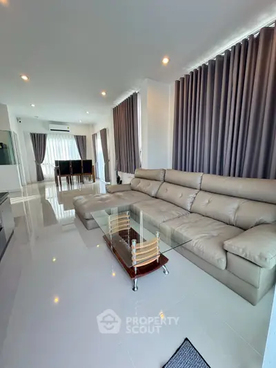 Spacious modern living room with elegant sectional sofa and glass coffee table