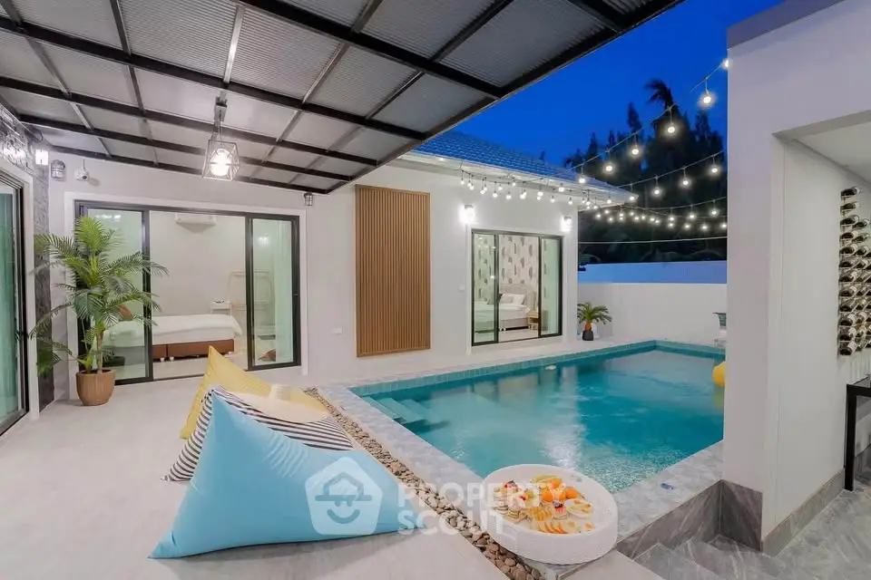Luxurious modern home with private pool and stylish outdoor seating area, perfect for relaxation and entertainment.