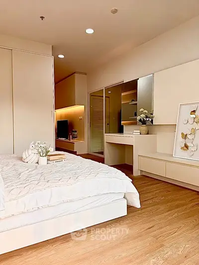 Modern bedroom with elegant decor and cozy ambiance, featuring a stylish vanity and soft lighting.