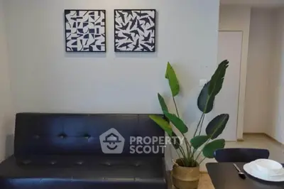 Modern living room with stylish black sofa and decorative plant