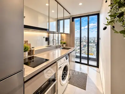 Modern kitchen with sleek appliances and city view from balcony