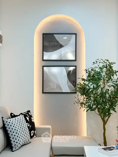 Stylish modern living room with elegant wall art and cozy seating area.