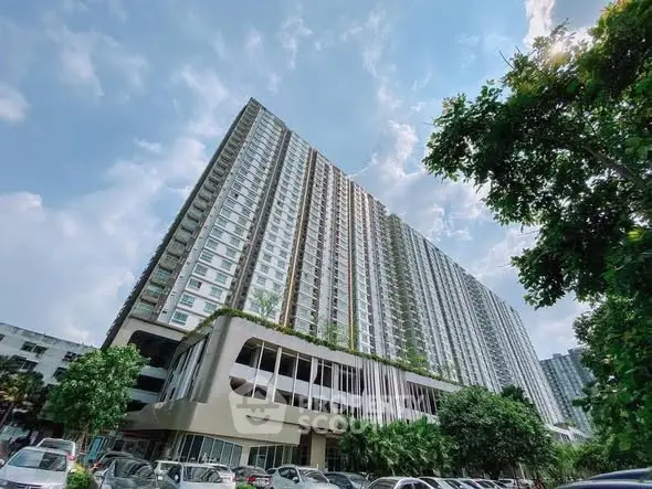 Stunning high-rise residential building with lush greenery and ample parking space.