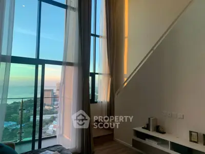 Stunning high-rise apartment with floor-to-ceiling windows and breathtaking ocean view.