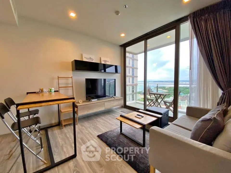 Modern living room with large windows and balcony offering stunning views