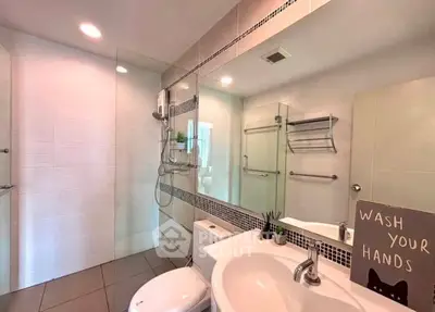 Modern bathroom with glass shower and stylish fixtures in a contemporary home.