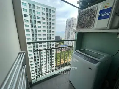 High-rise apartment balcony with washing machine and city view