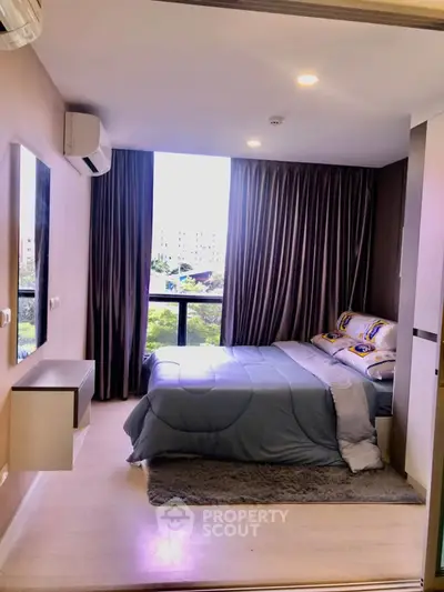 Modern bedroom with large window and stylish decor in a high-rise apartment.