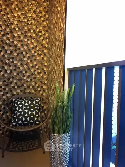 Stylish balcony with modern decor and unique wall design, perfect for relaxation.