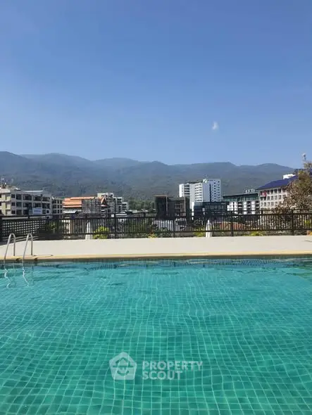 Stunning rooftop pool with panoramic mountain and city views, perfect for relaxation and leisure.