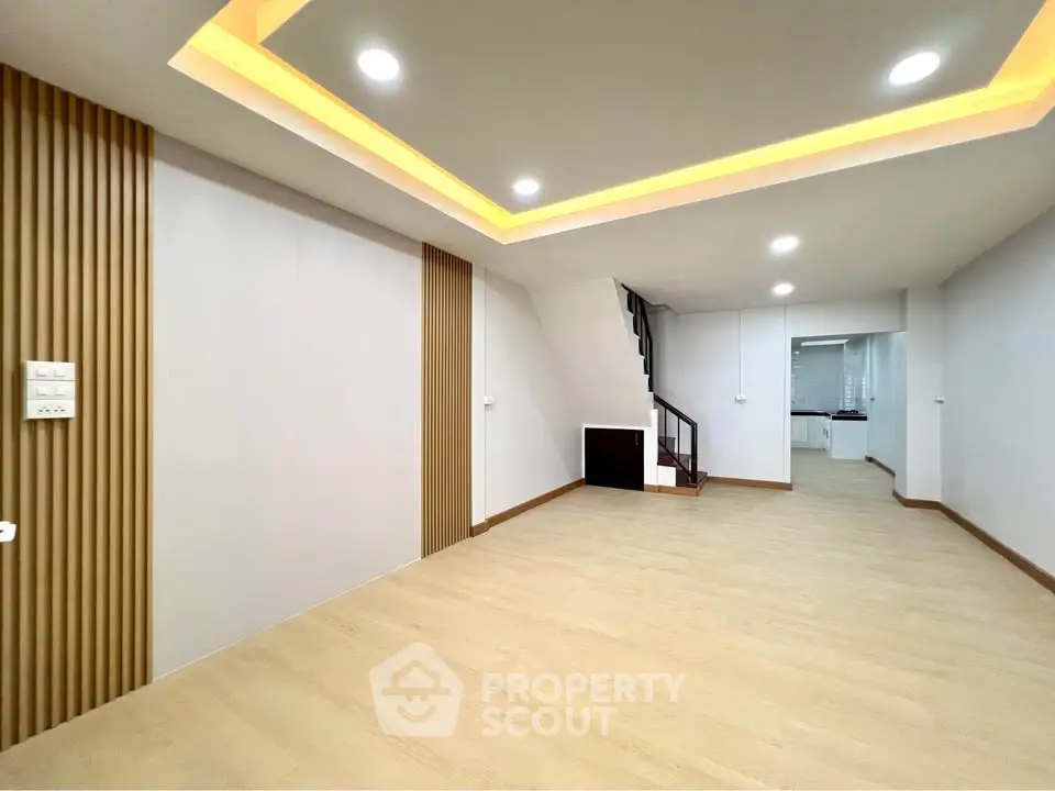 Spacious modern living room with stylish ceiling lights and open layout