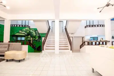 Spacious modern living room with unique staircase and stylish decor