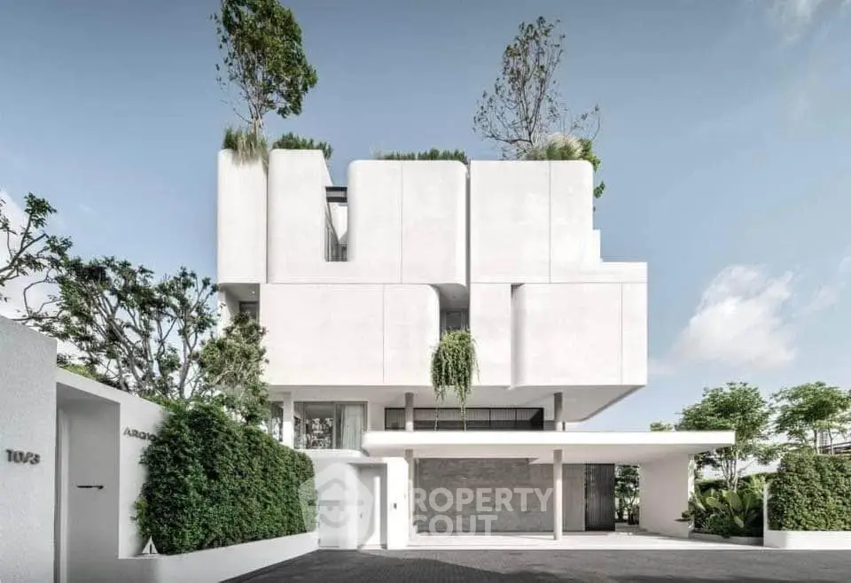 Stunning modern architectural masterpiece with lush greenery and sleek design, perfect for luxury living.