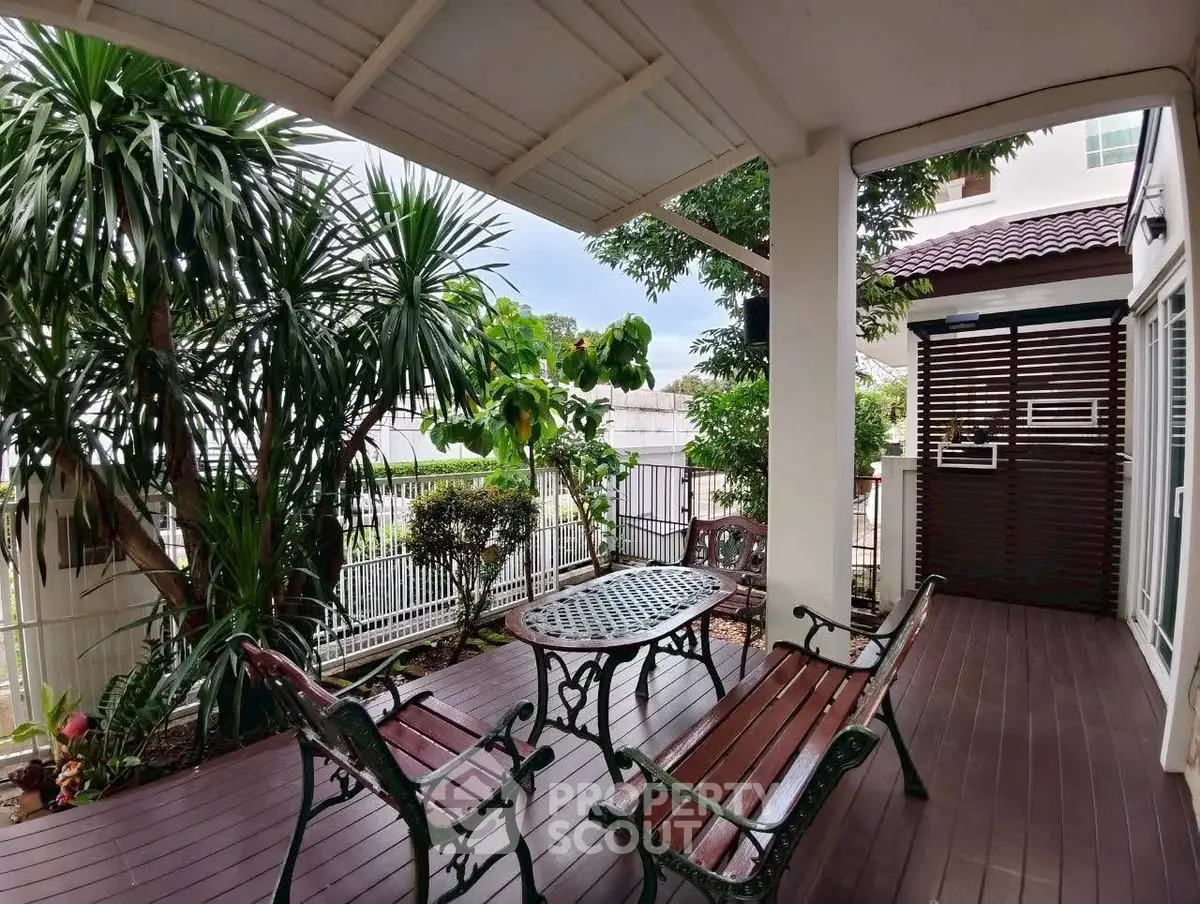 Charming garden patio with elegant seating and lush greenery, perfect for relaxation and outdoor gatherings.