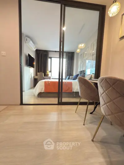 Modern bedroom with glass sliding doors and elegant dining area