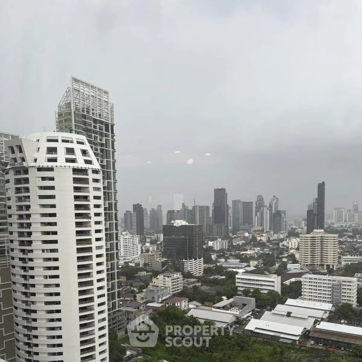 Stunning cityscape view showcasing modern high-rise buildings under a cloudy sky.