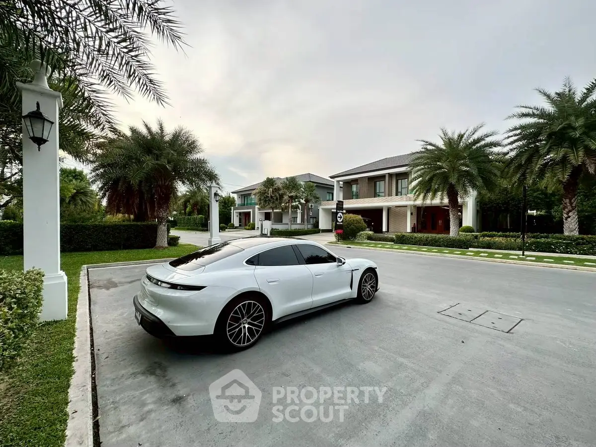 Luxurious modern villa with sleek driveway and lush landscaping