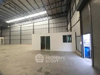 Spacious industrial warehouse with high ceilings and office space