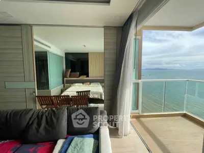 Stunning oceanfront apartment with floor-to-ceiling windows and spacious balcony offering breathtaking sea views.