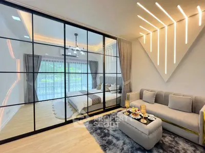 Modern living room with glass partition and stylish lighting in a cozy apartment