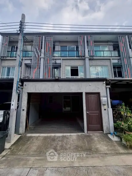 Modern three-story townhouse with garage and contemporary facade