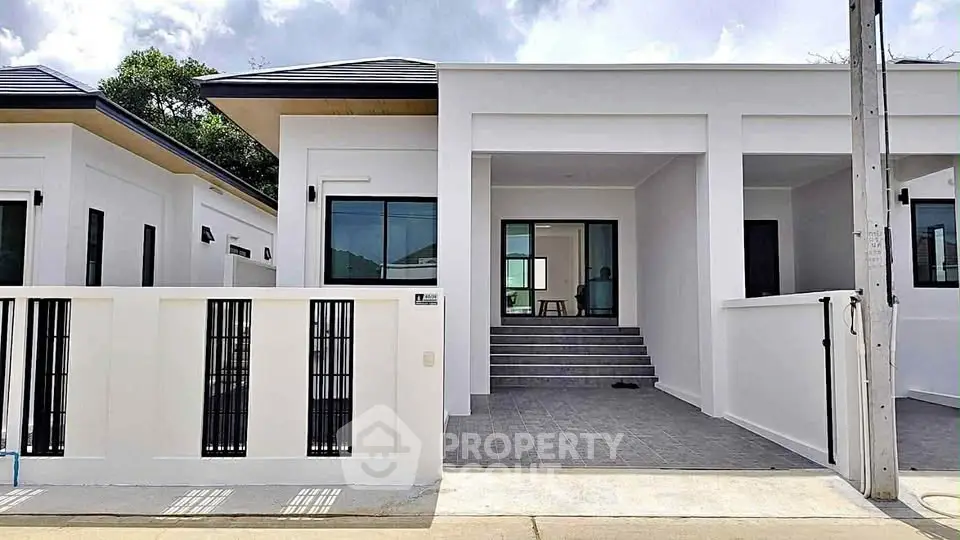Modern minimalist white house exterior with clean lines and large windows