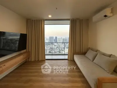 Spacious living room with city view and modern furnishings