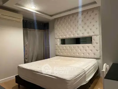 Luxurious bedroom with plush headboard and modern lighting