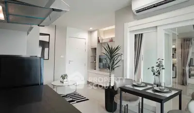 Modern living room with sleek decor and dining area in a stylish apartment.
