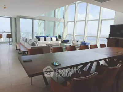 Luxurious penthouse living room with panoramic city views and elegant modern furnishings.