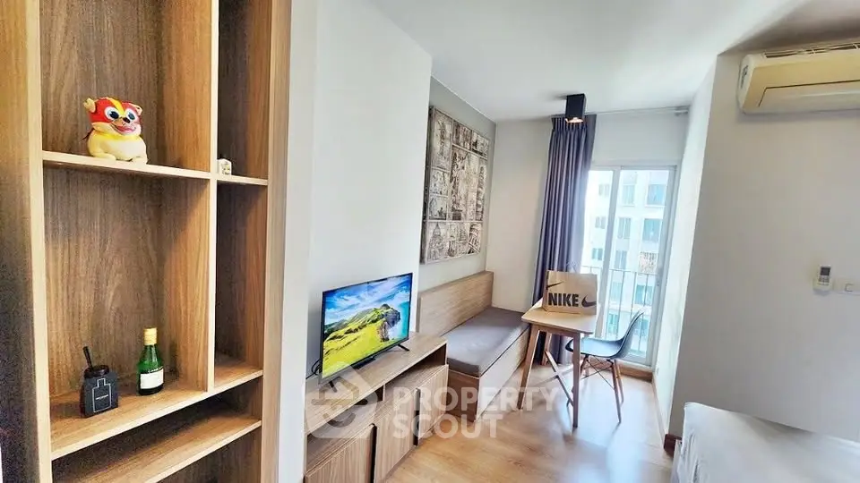 Modern living room with wooden furniture and balcony view in a cozy apartment.