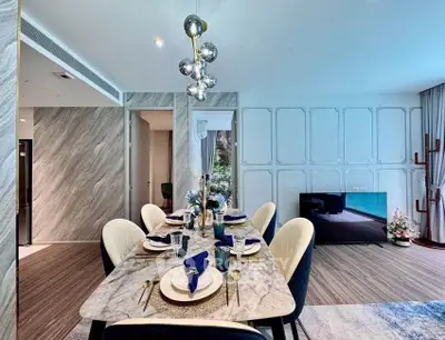 Luxurious dining area with elegant marble table and modern decor in a stylish living room setting.