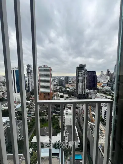 Stunning cityscape view from high-rise balcony with modern urban skyline.