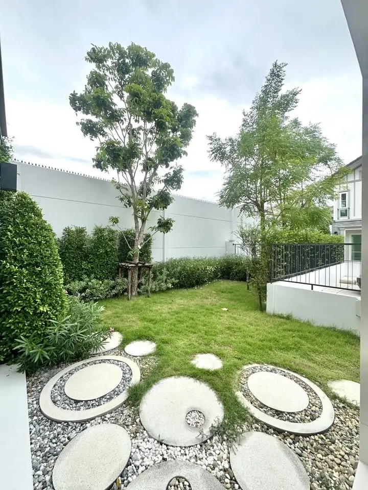 Charming garden with modern landscaping and lush greenery in a serene residential setting.