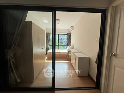 Modern bedroom with sliding glass doors and natural light