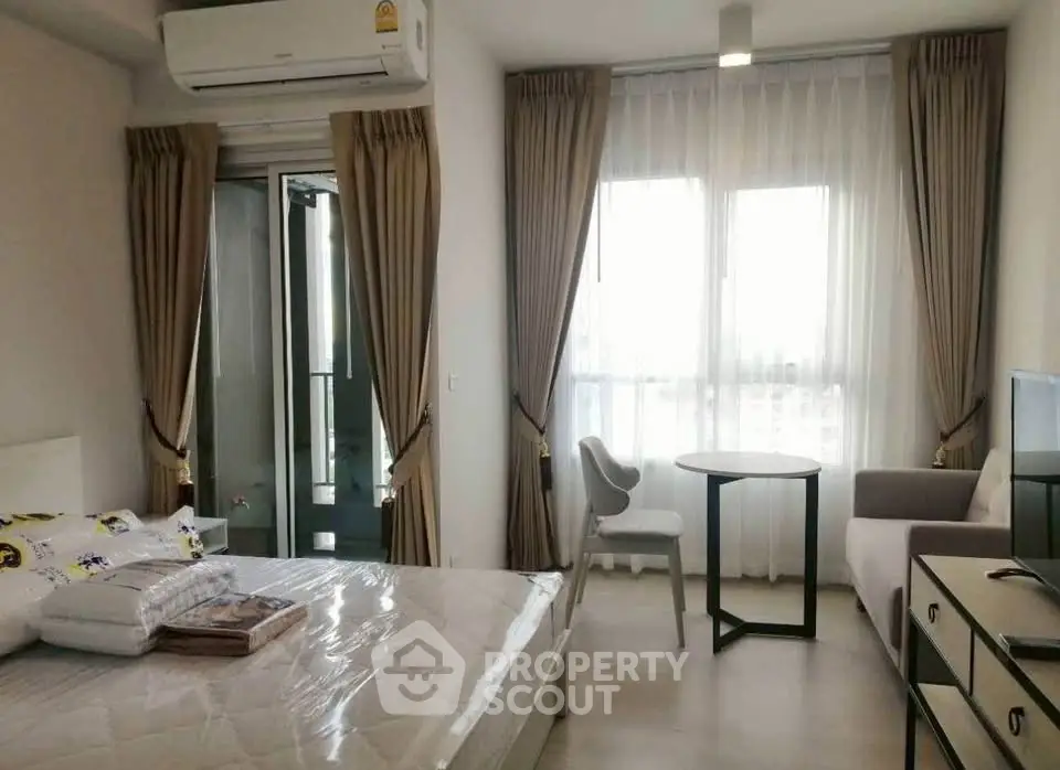 Modern bedroom with balcony access, featuring stylish furniture and natural light.