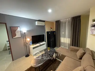 Cozy living room with modern decor and comfortable seating in a stylish apartment.