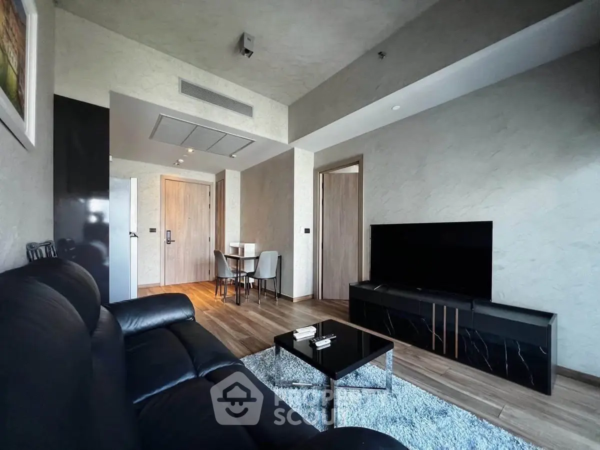Modern living room with sleek black furniture and stylish decor, perfect for contemporary urban living.