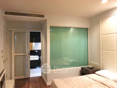 Modern bedroom with ensuite bathroom and stylish glass partition
