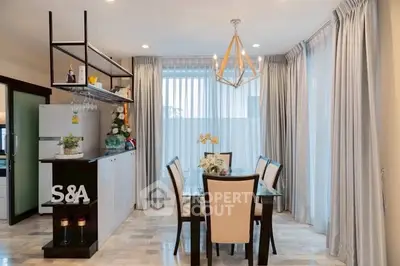 Elegant dining area with modern chandelier and open kitchen layout in a stylish home.