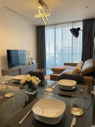 Modern living room with elegant dining setup and city view through large windows.